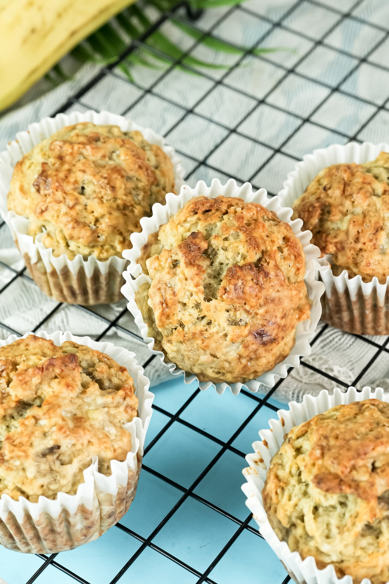 Top view of golden-brown banana protein muffins on a cooling rack