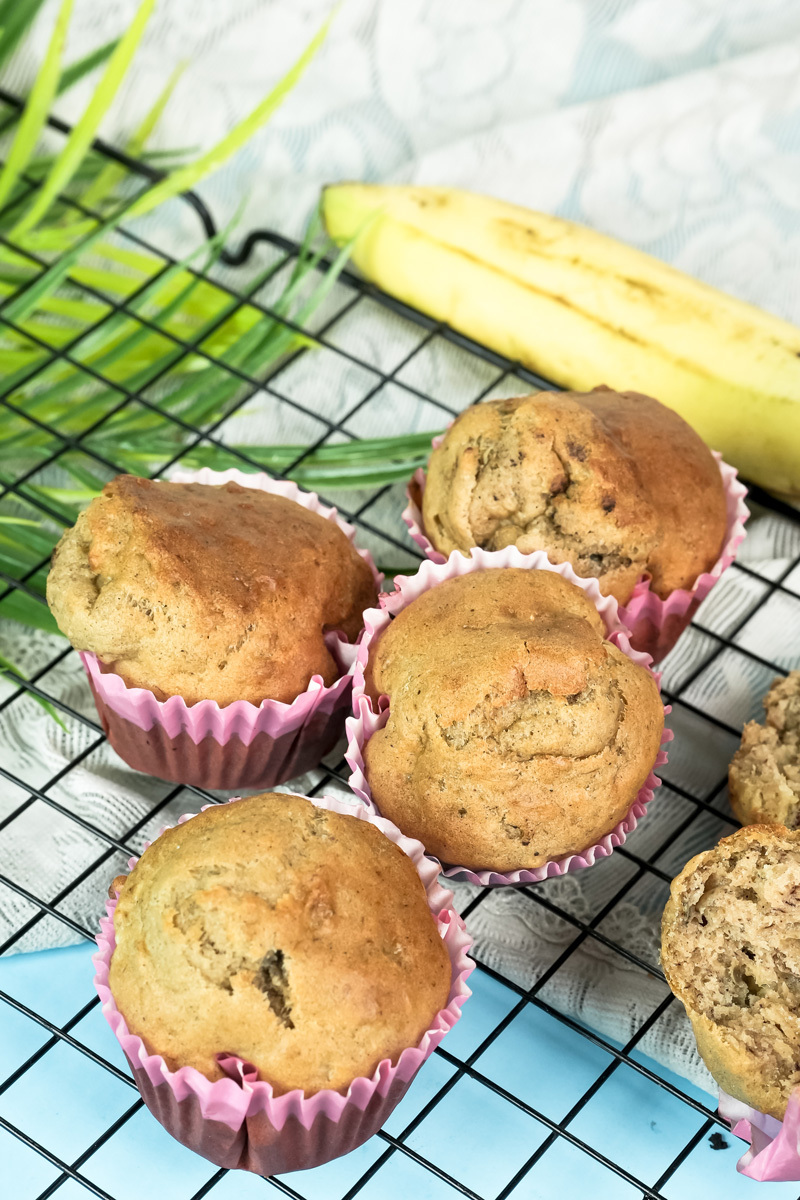 A group of delicious banana muffins cooling on a wire rack