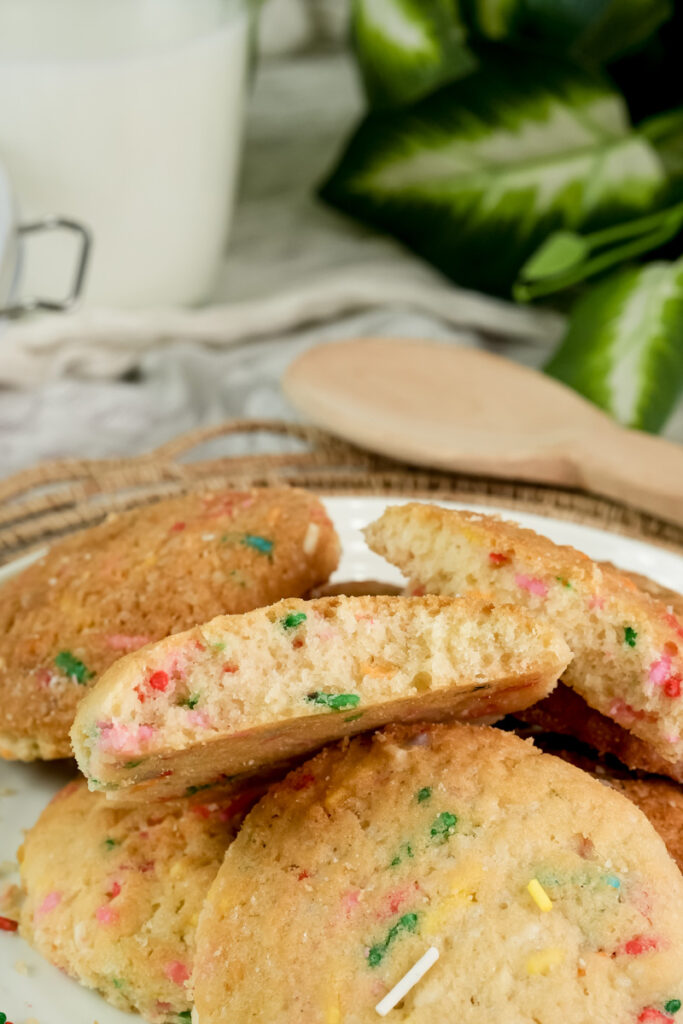 A close-up of a halved Funfetti cookie showing its soft, sprinkle-filled interior