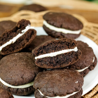 A homemade Oreo cookie broken in half to show the creamy white filling