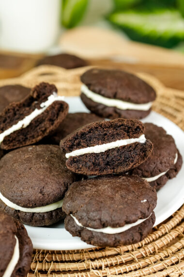A homemade Oreo cookie broken in half to show the creamy white filling