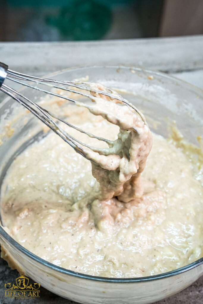 Close-up of the mixed banana muffin batter on a wire whisk