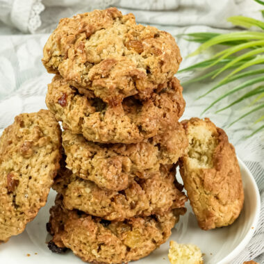 Stack of oatmeal raisin cookies on white serving plate