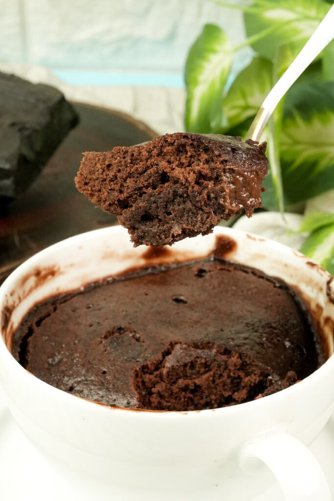 A spoonful of fudgy, low calorie chocolate mug cake showing the soft interior