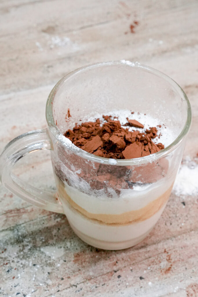 Adding unsweetened cocoa powder to a gluten-free mug cake