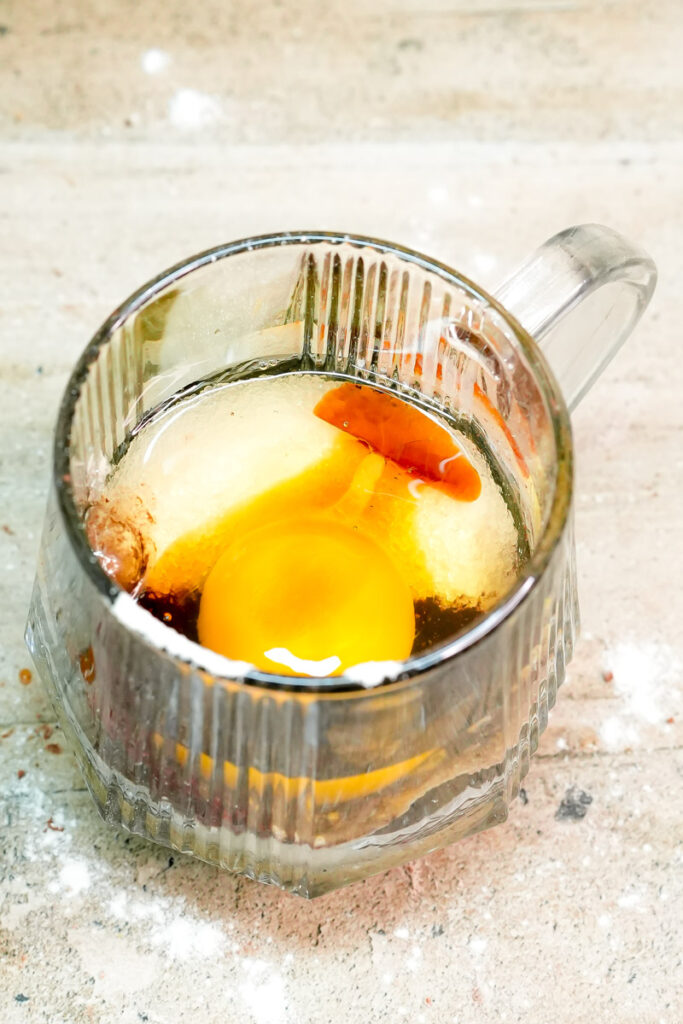 Adding vanilla extract to the chocolate mug cake batter