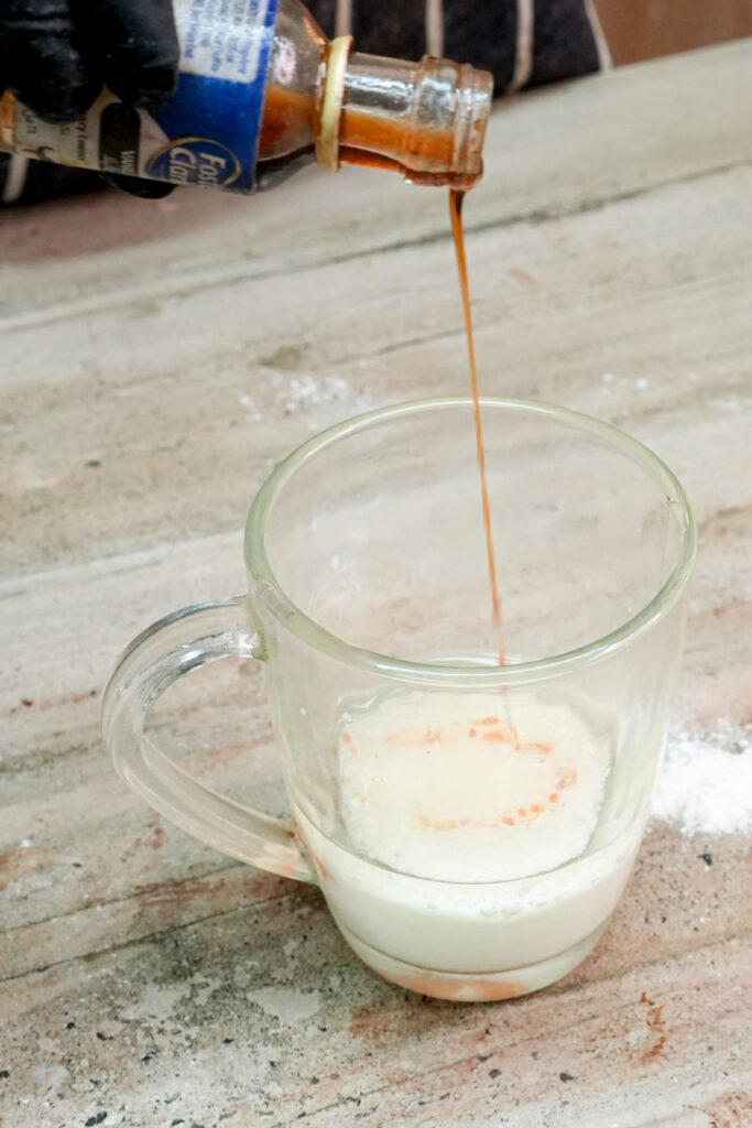 Adding vanilla extract to wet ingredients in a mug
