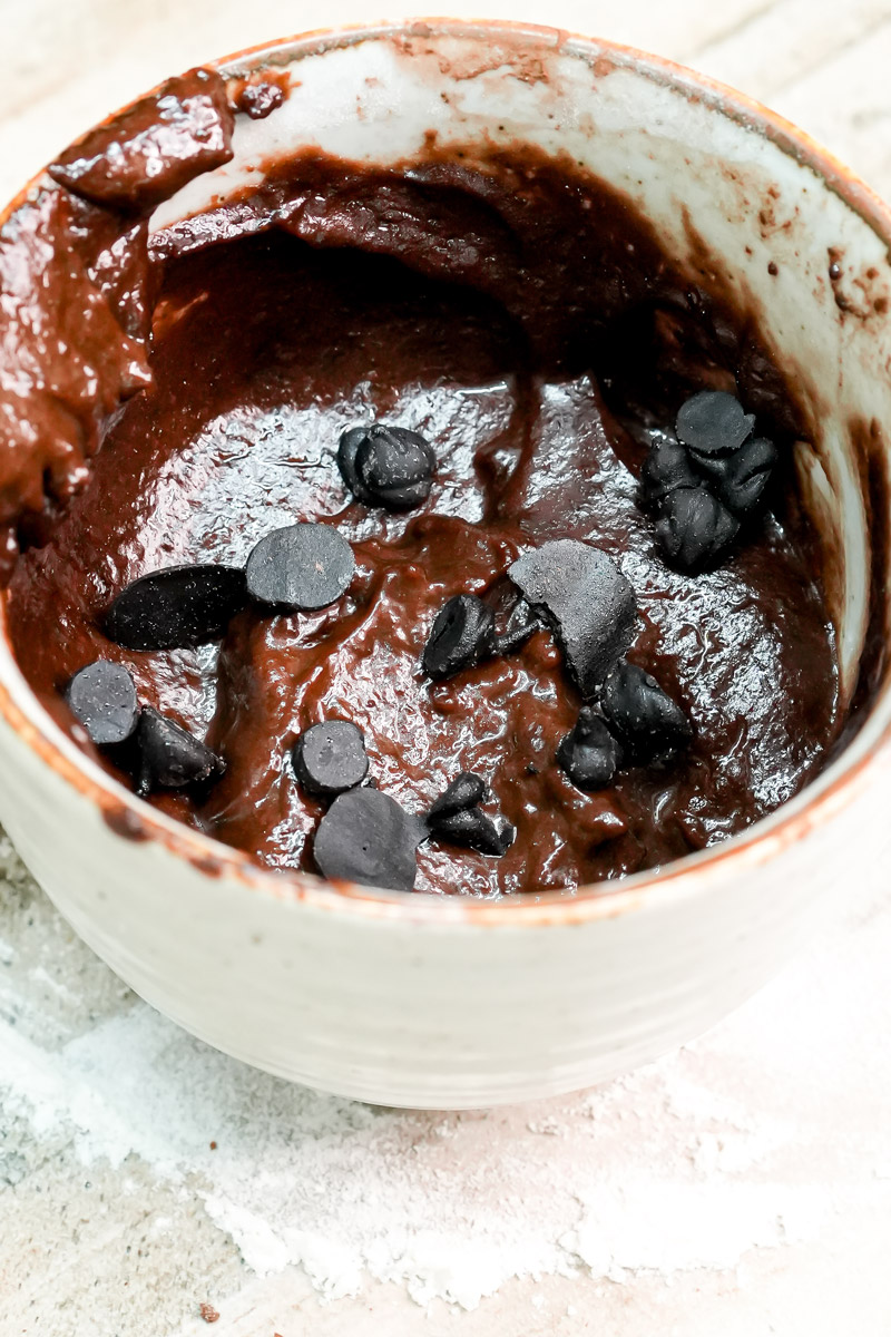 Brownie mug cake batter topped with dark chocolate chips before baking