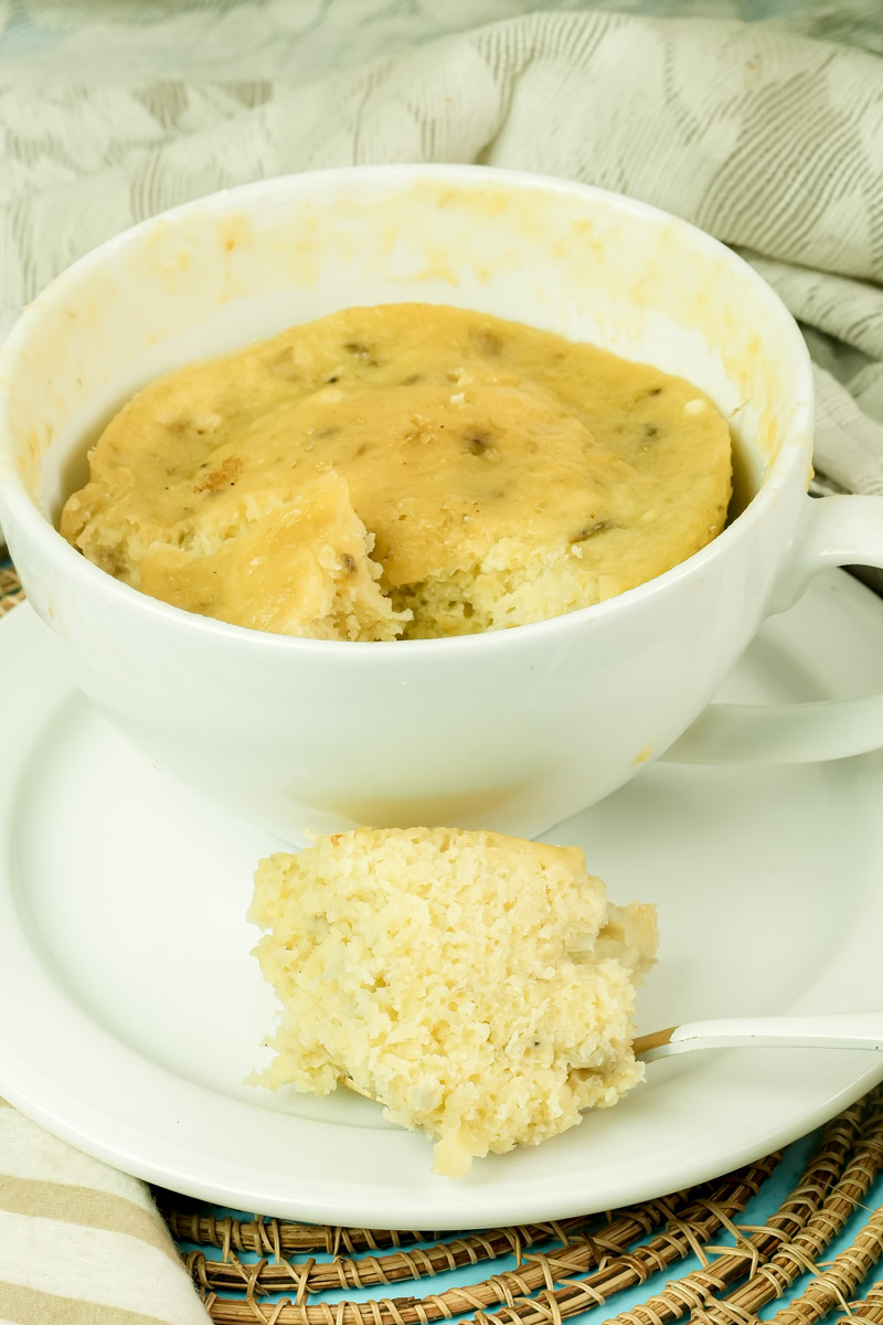 Finished banana mug cake displaying its moist, cooked center and golden top.