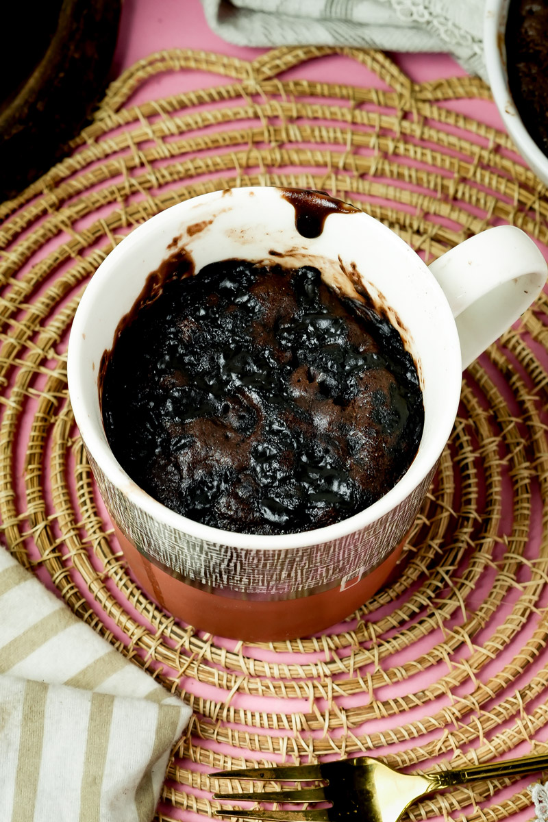 Finished chocolate mug cake with a glossy, melted chocolate top
