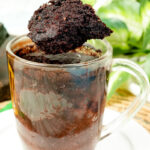 Fluffy chocolate gluten-free mug cake bite held up on a spoon