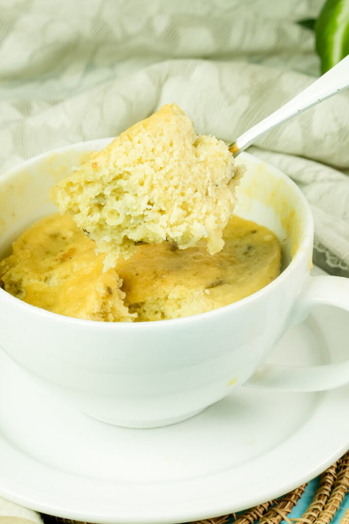 Freshly cooked banana mug cake piece on a spoon