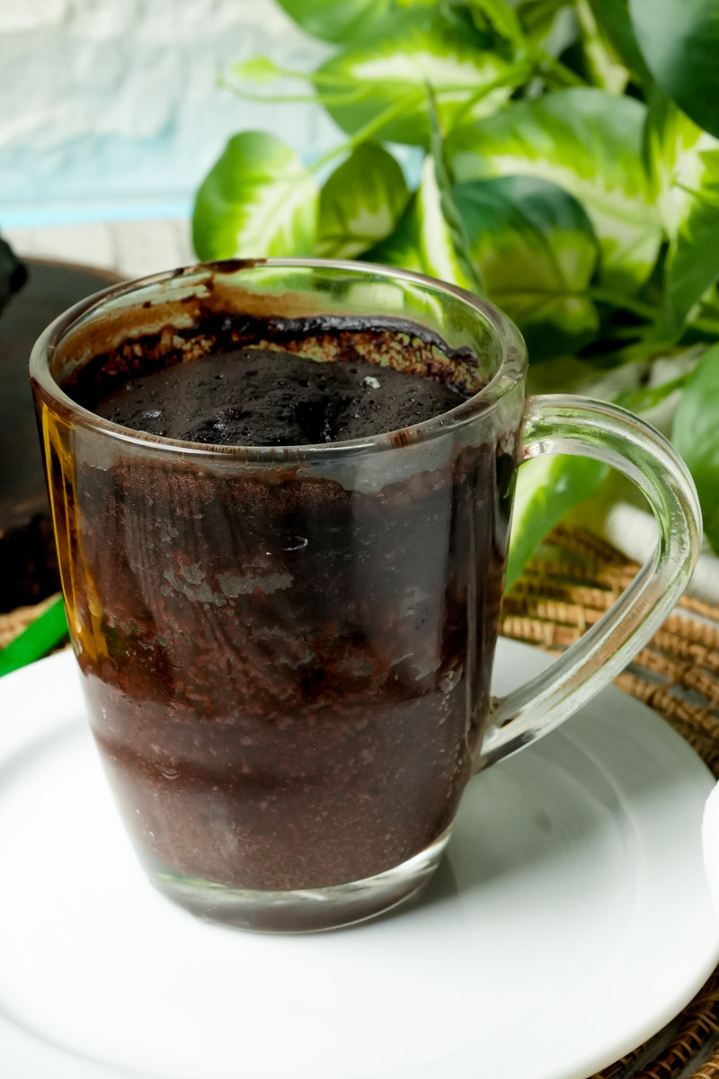 Freshly baked chocolate gluten-free mug cake in a glass mug