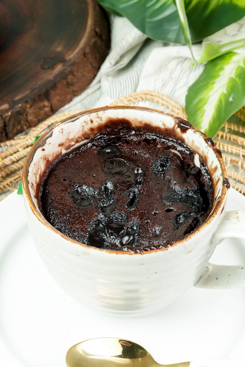 Freshly baked chocolate mug brownie with melted chocolate chips