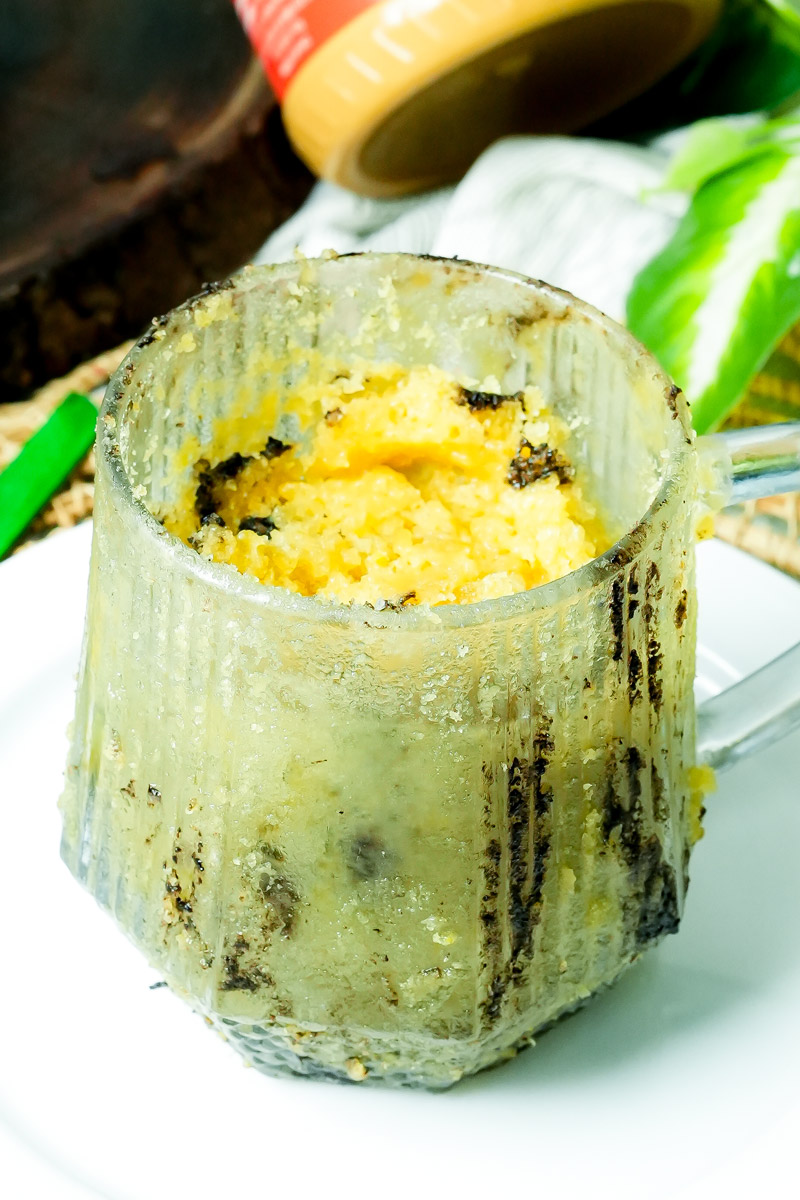 Freshly baked peanut butter mug cake in a clear glass mug