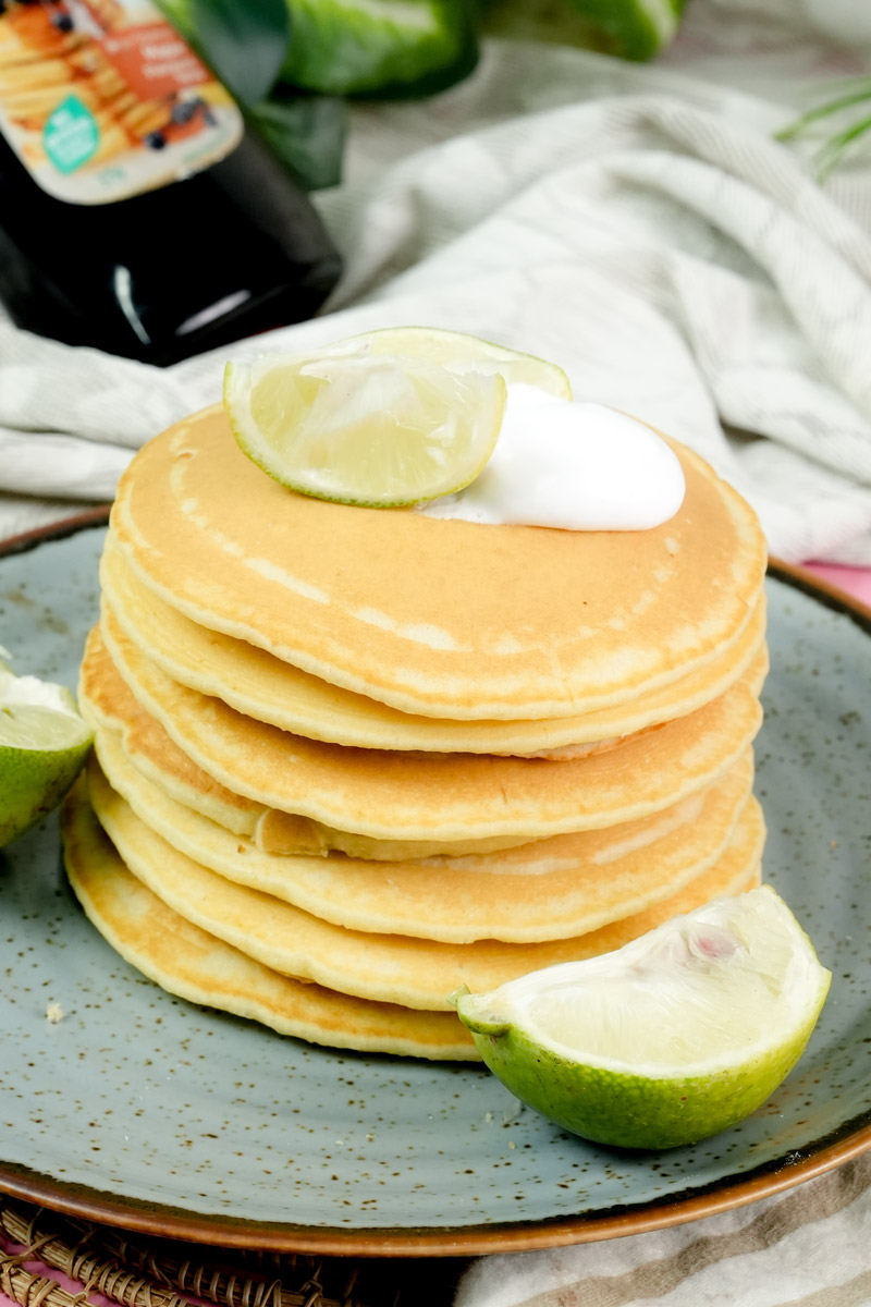 Homemade lemon pancakes served on a blue plate with citrus slices