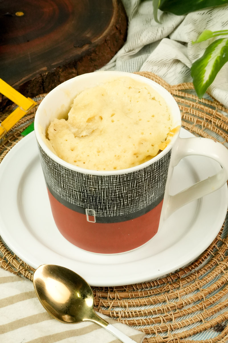 Homemade vanilla mug cake served on a white saucer