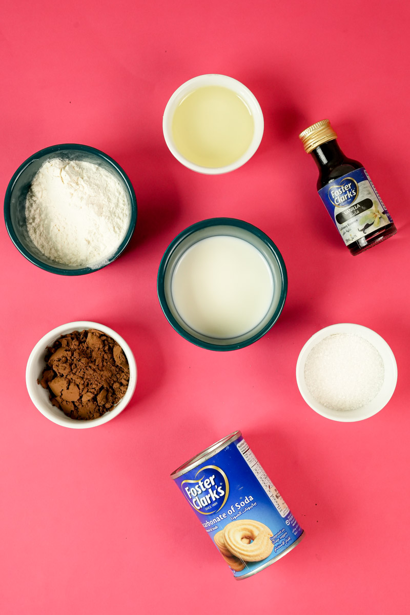 Ingredients for gluten-free mug cake including flour, cocoa, and milk