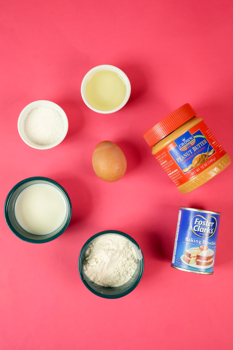 Ingredients for peanut butter mug cake including egg, flour, sugar, and milkIngredients for peanut butter mug cake including egg, flour, sugar, and milk