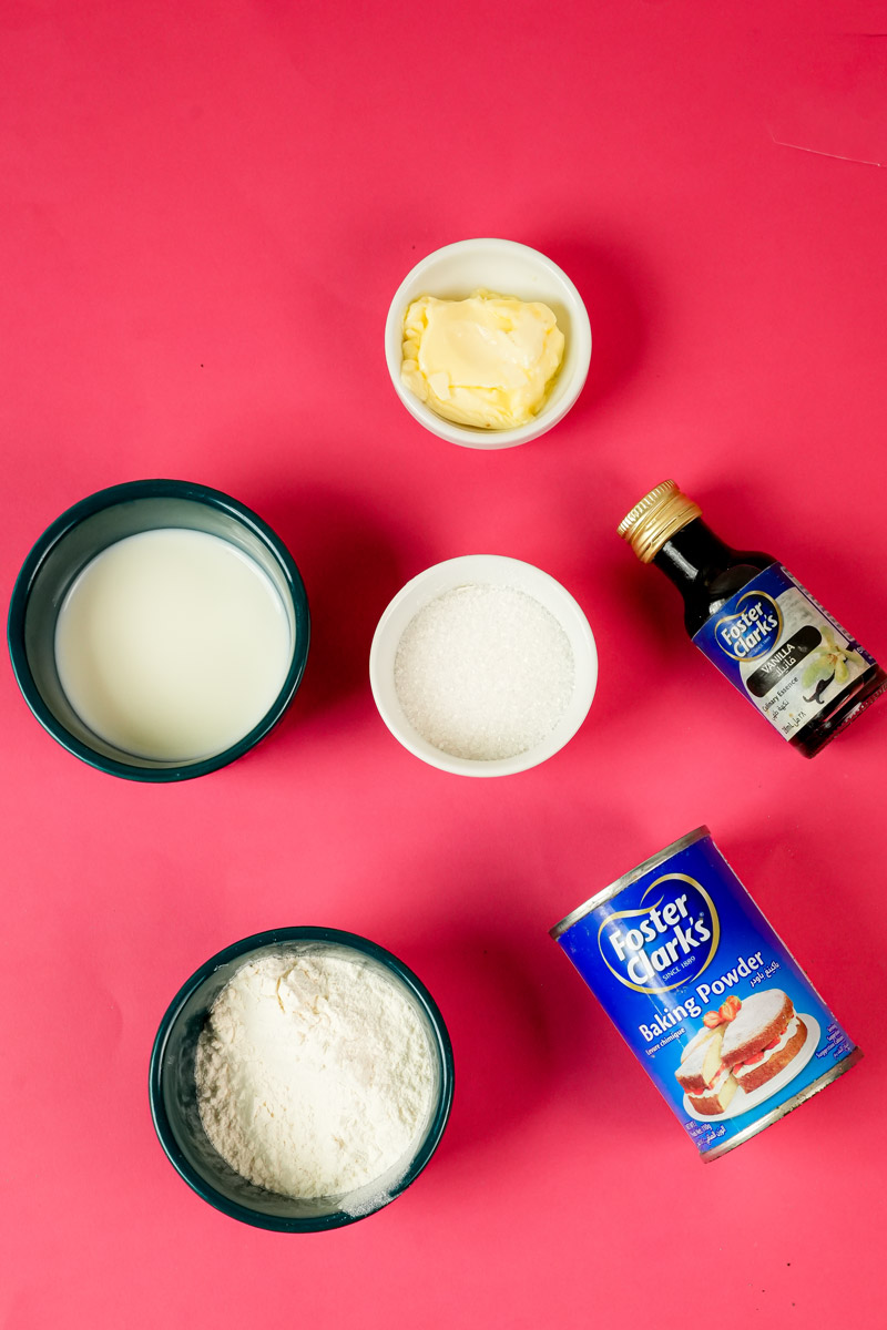 Ingredients for vanilla mug cake including flour, milk, butter, and vanilla extract