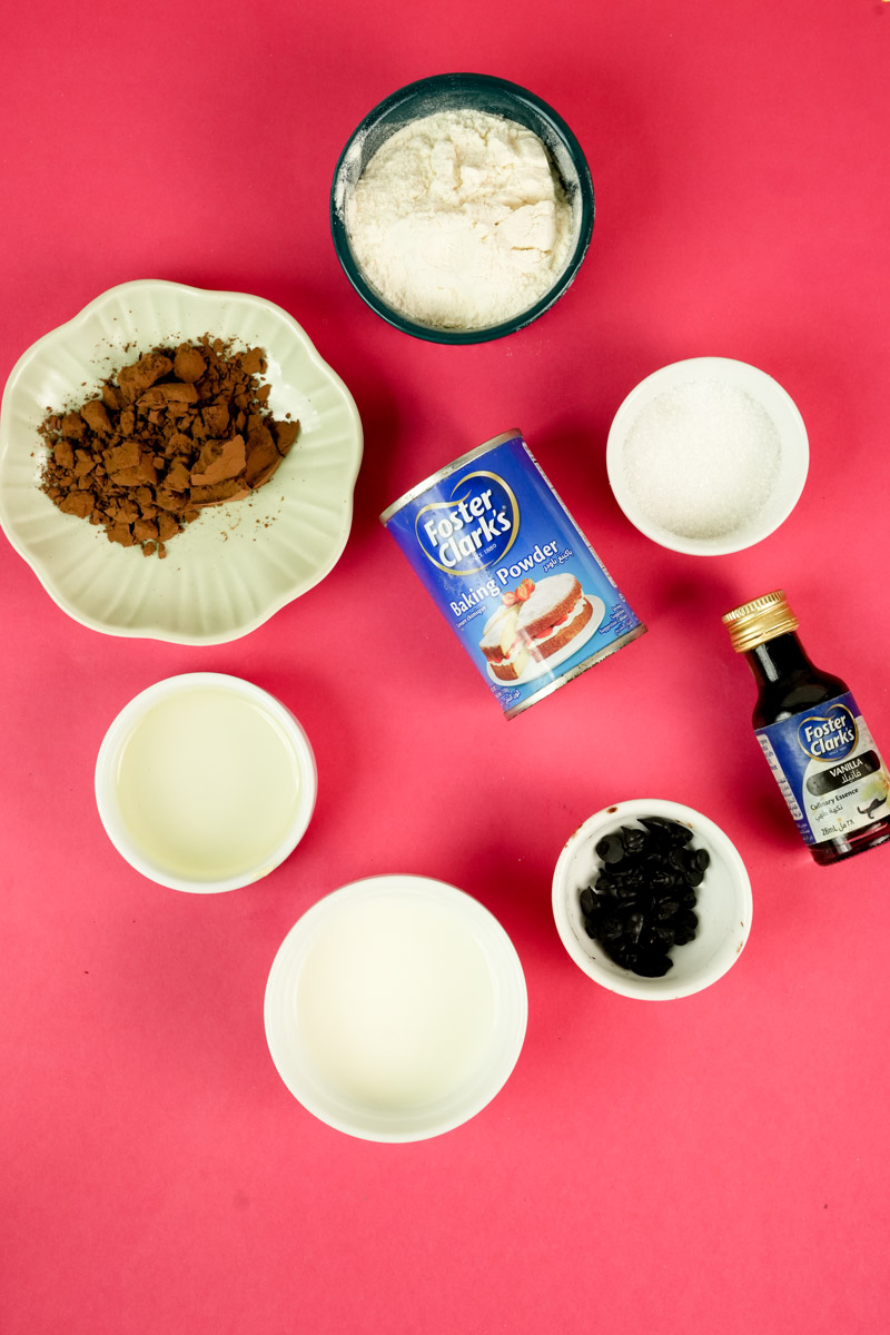 Ingredients for vegan chocolate mug cake on a pink background