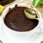 Low calorie chocolate mug cake ready to eat with a gold spoon
