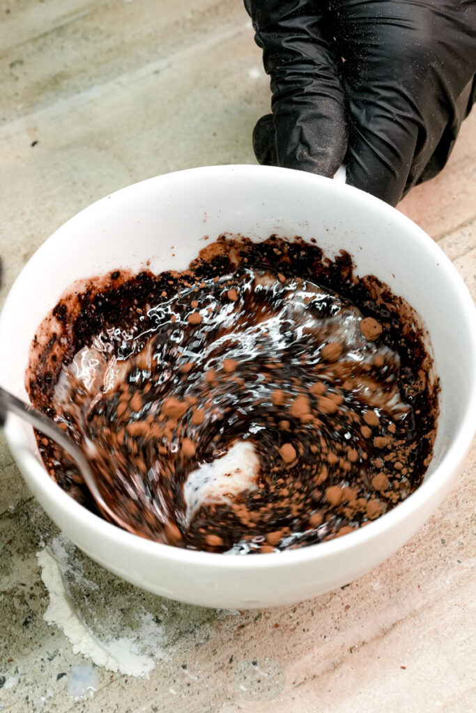 Mixing chocolate mug cake batter until smooth