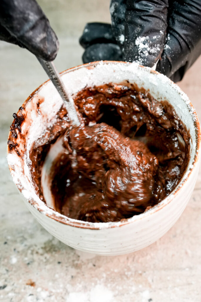 Mixing flour and chocolate batter together in a mug