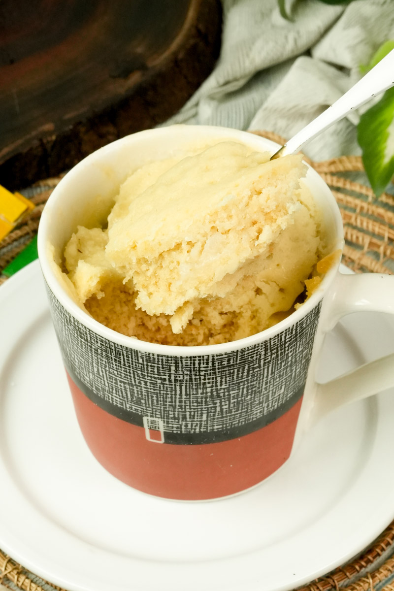 Scooping out a warm piece of homemade vanilla mug cake