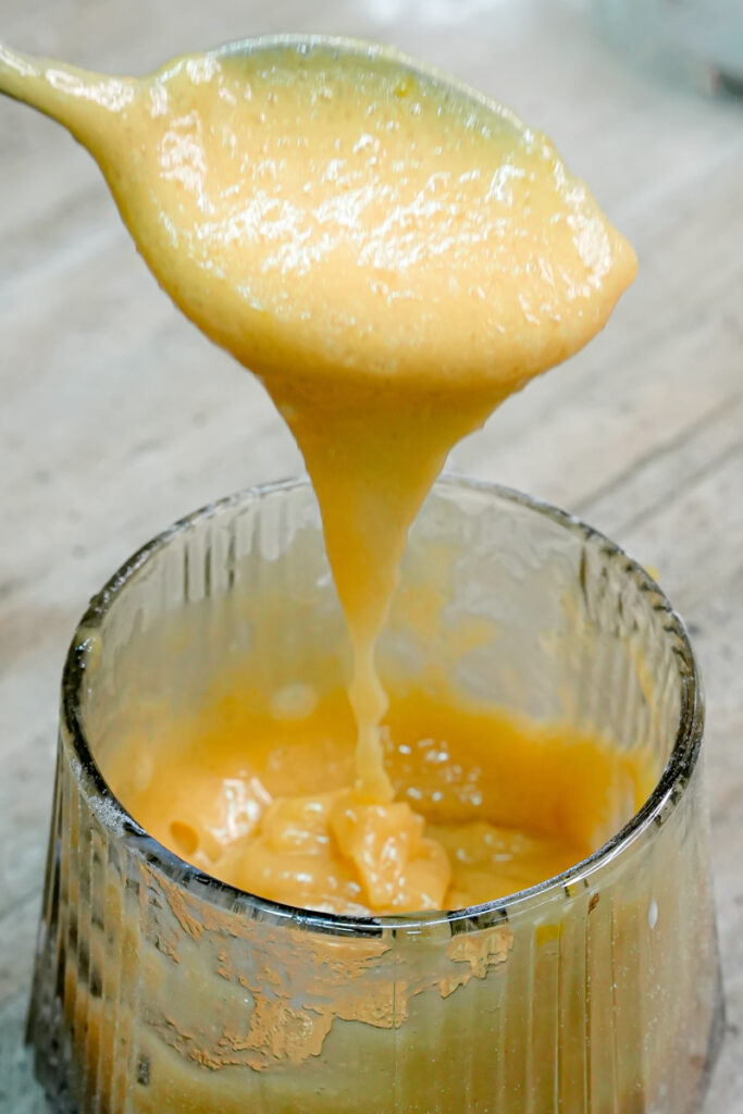 Smooth and creamy peanut butter mug cake batter on a spoon