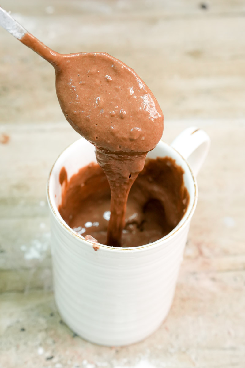 Smooth chocolate batter dripping into the mug