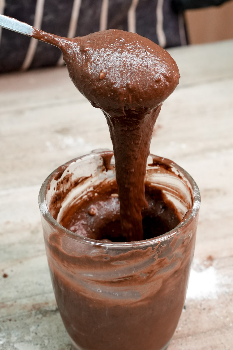 Thick gluten-free chocolate mug cake batter on a spoon