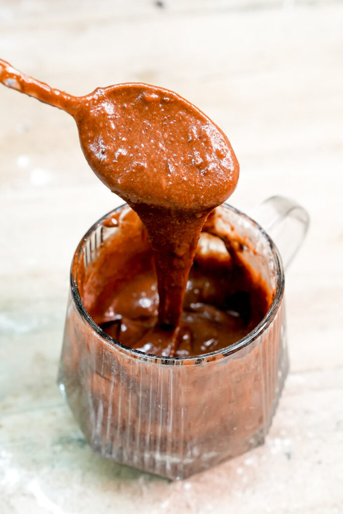 Smooth, thick keto chocolate cake batter in a mug