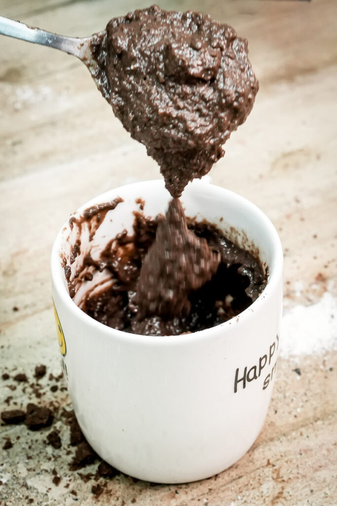 Stirring Oreo mug cake batter with a spoon until smooth