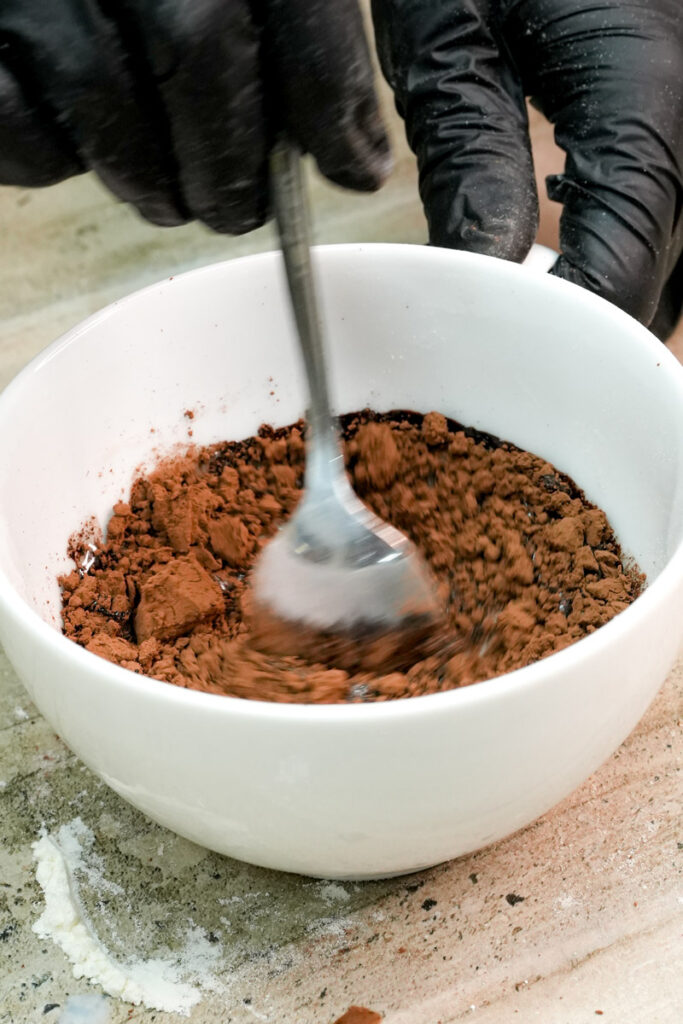 Stirring cocoa powder and wet ingredients for chocolate cake