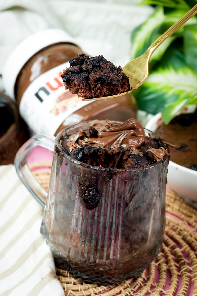 Taking a spoonful of keto chocolate mug cake with hazelnut spread