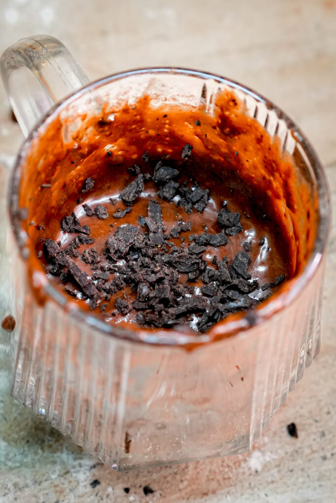 Topping keto mug cake batter with sugar-free chocolate chips