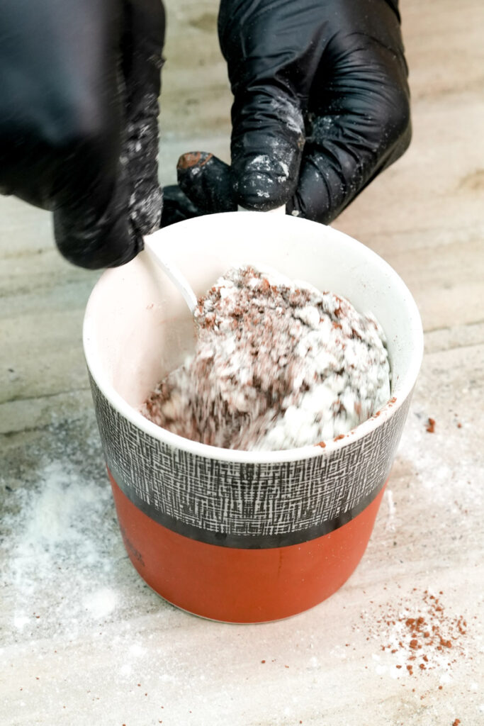 Whisking mug cake batter ingredients with a spoon