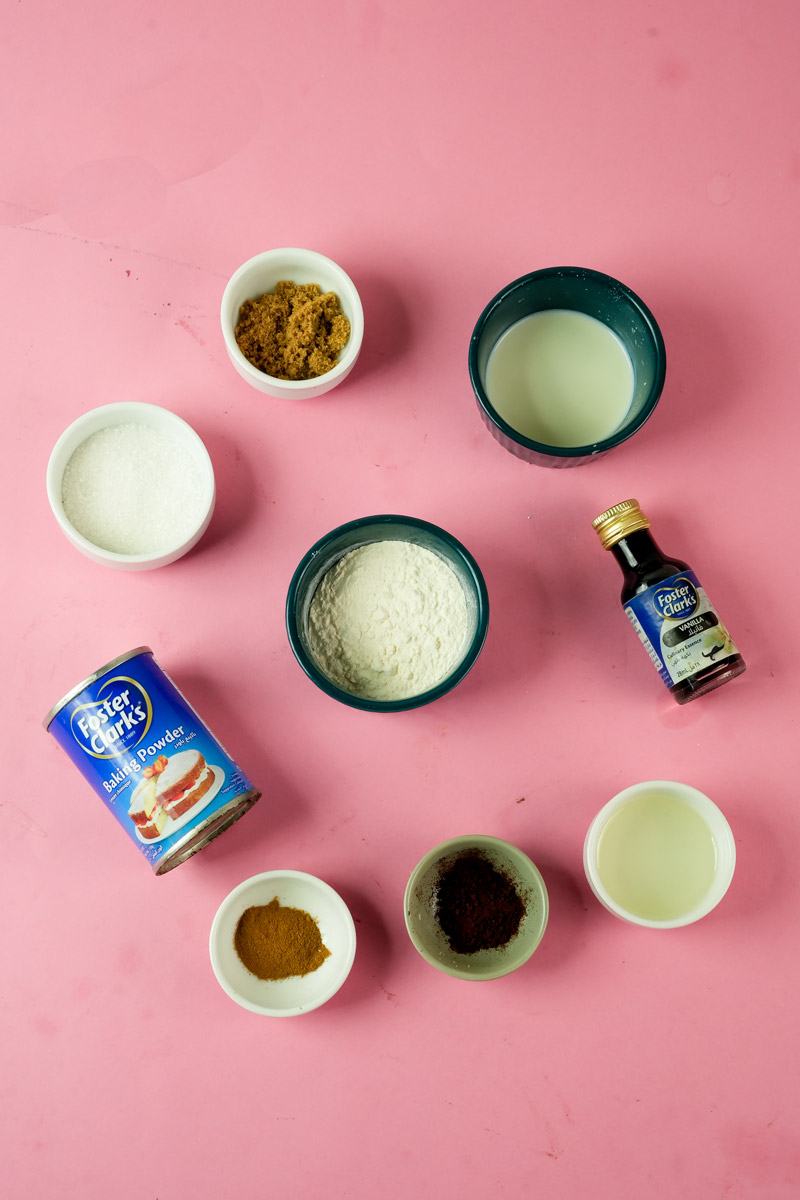 Overhead view of coffee mug cake ingredients including flour, sugar, espresso powder, and baking powder