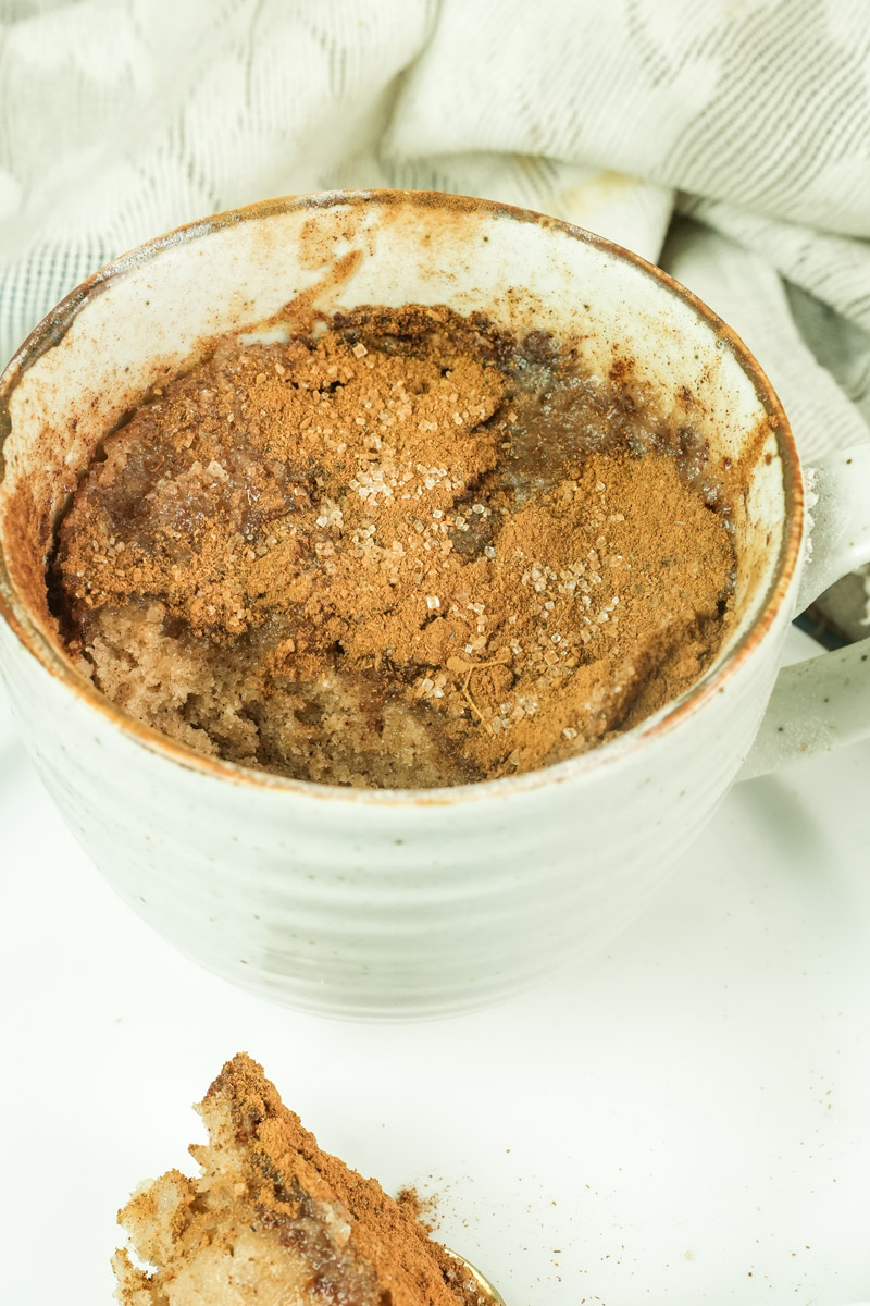 Inside view of a cooked snickerdoodle mug cake showing the crumb and cinnamon layer
