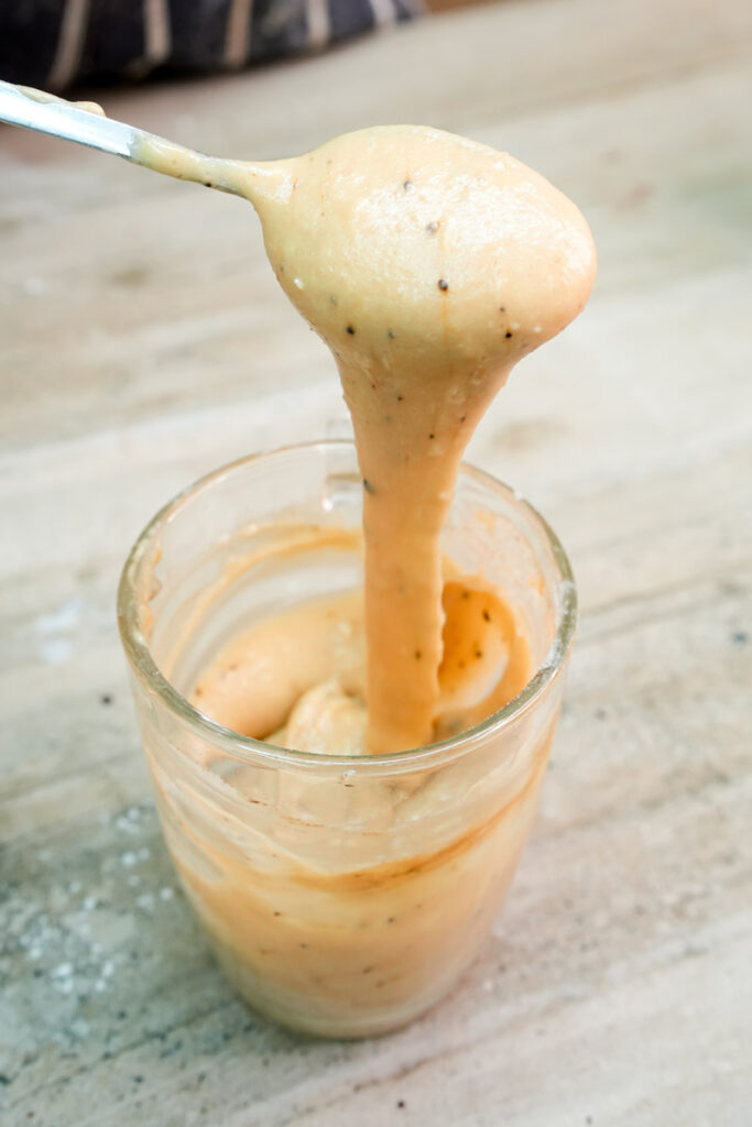 Close-up of thick, creamy coffee-flavored cake batter on a spoon