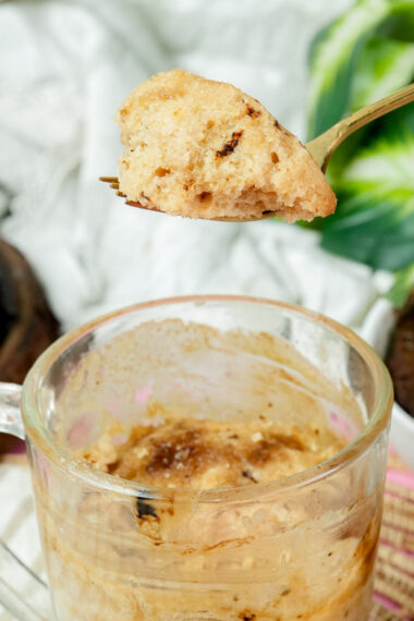 Close-up of the crumb texture of a microwave coffee mug cake on a gold fork