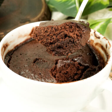 Close-up of a fluffy bite of chocolate mug cake highlighting the airy crumb