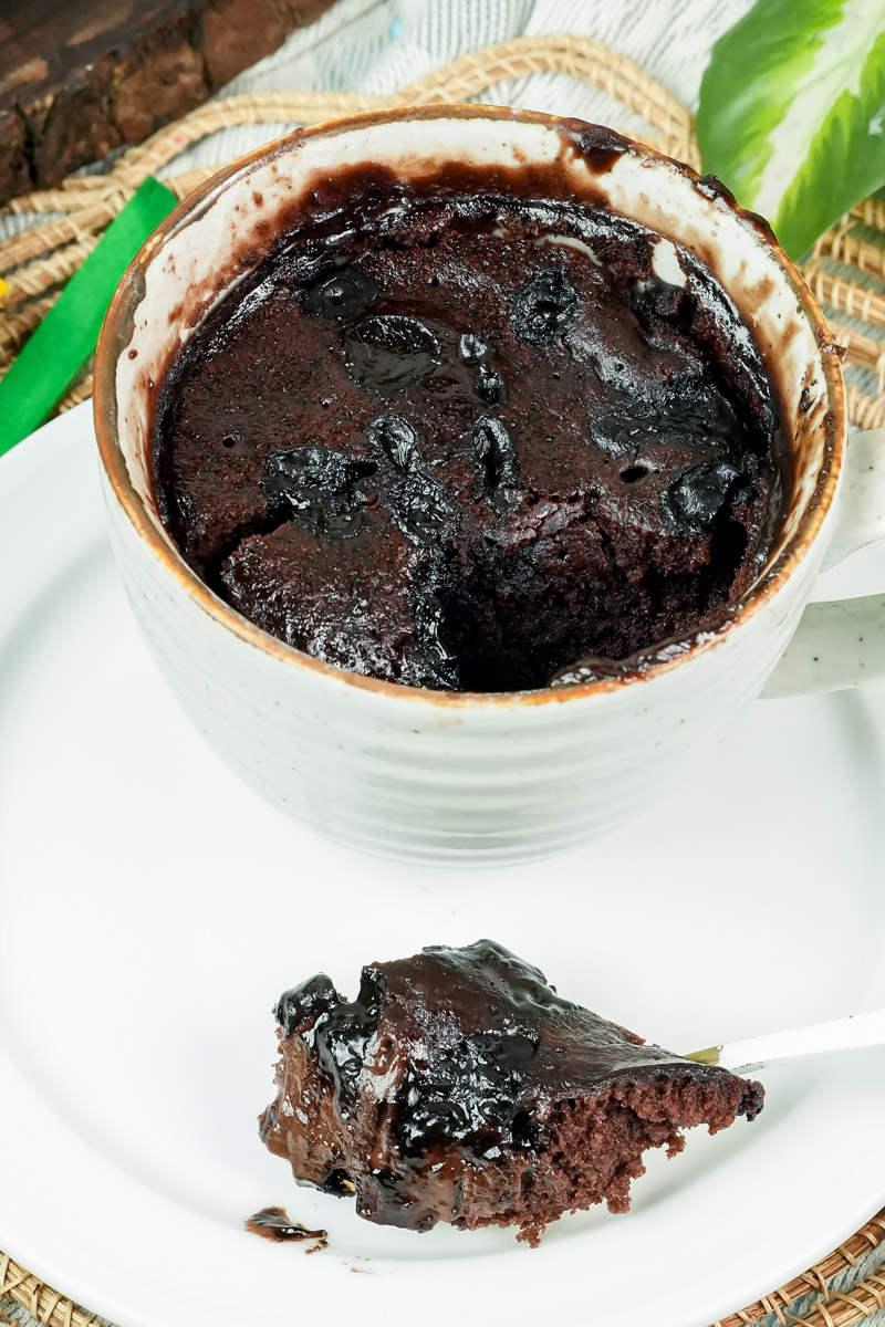 Top view of a half-eaten chocolate brownie in a mug