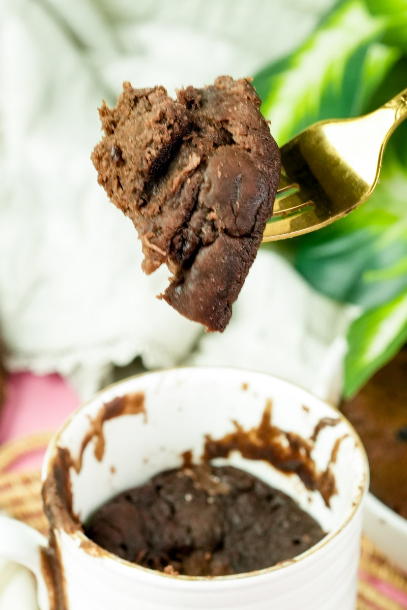 A bite-sized chunk of healthy chocolate mug cake ready to eat