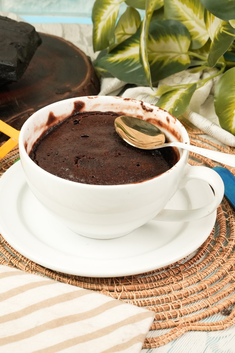 A quick and healthy microwave chocolate mug cake served on a white saucer