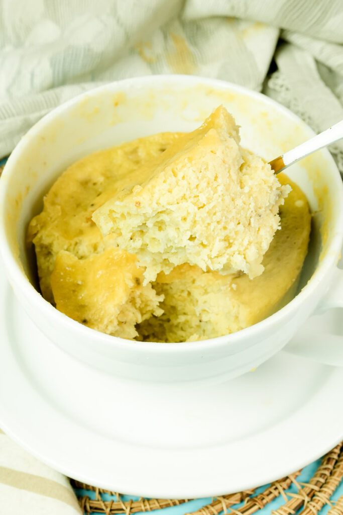 Close-up of the interior texture of a microwave banana mug cake on a spoon