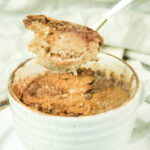 Close-up of a bite-sized piece of snickerdoodle cake on a gold spoon