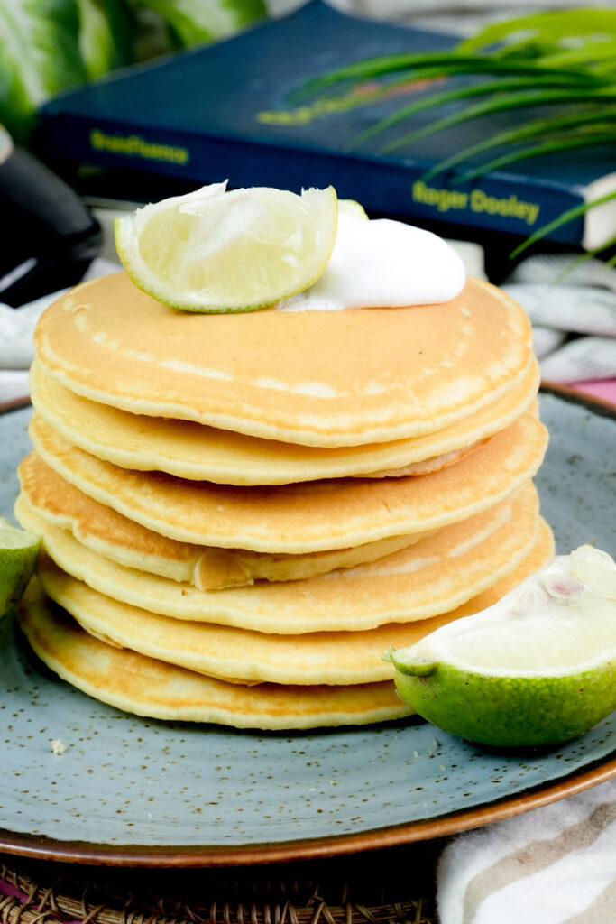 Vertical shot of a tall stack of golden brown lemon pancakes