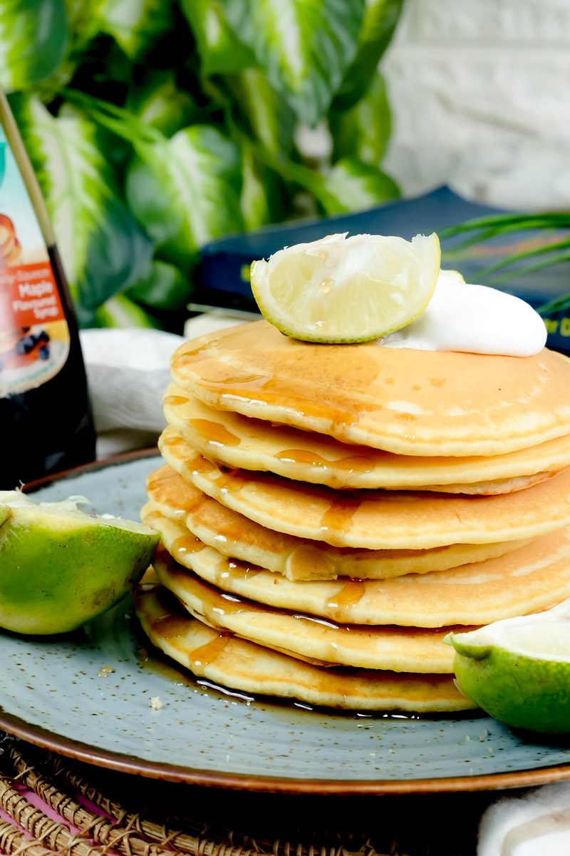 Close-up of syrup dripping down the sides of fresh citrus pancakes